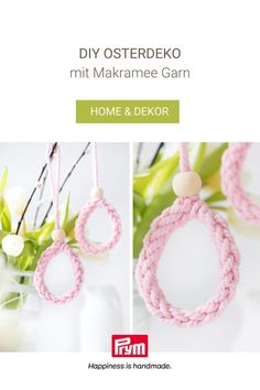 some pink rope hanging from a white vase with flowers in it and the words diy osterdeko mit makrame garn home & dekor