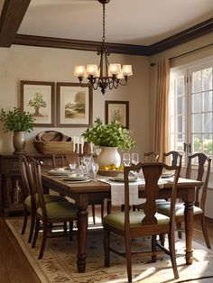 a dinning room table with chairs and pictures on the wall