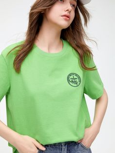 Details: Youthful and vibrant green tinted tee with a touch of nature.Fitted short fitEmbroidered design on the chestIt is cool and suitable for spring and summer wear. Materials & Care: Cotton: 63.3%; Polyester: 20.6%; Lycra: 16.1% Hand wash | Dry clean Do not bleach Size & Fit: Model is 5'7", Bust 32, Waist 24, Hips 35, wearing a size S Item #: LN1TE22 Green Casual T-shirt For Spring, Trendy Green T-shirt For Summer, Green Sporty Tops For Summer, Green Sporty Summer Tops, Light Green Short Sleeve Tops For Spring, Green Graphic Tee For Summer, Green Crew Neck T-shirt For Summer, Light Green Short Sleeve Cotton Top, Light Green Cotton Short Sleeve Top