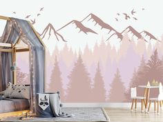 a bedroom decorated in pink and grey with mountains on the wall