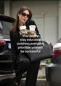 a woman is holding a tray with drinks in her hand and drinking from a cup