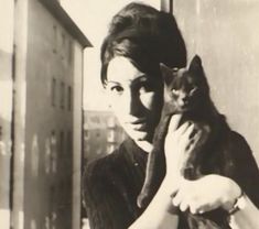 black and white photograph of a woman holding a cat