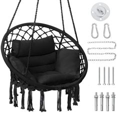 a hanging chair with black cushions and chains