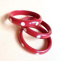 "Vintage inspired reproduction bakelite bangles, in Fun Fakelite, resin, designed made in red fun Fakelite with cream polka dots. This bangle is perfect to give a touch of color at any outfits. The listing is for one bangle. Inside Diameter 6.5cm \"Mrs Polly's Lucite\", Italy PLEASE NOTE : For customers outside of Italy, if you need a tracked shipping service, please select \"Tracked\" for your shipping option at checkout or send me a message before purchasing." Retro Bakelite Jewelry As Gift, Handmade Bakelite Bangle Bracelet, Vintage Plastic Jewelry For Gifts, Retro Bakelite Jewelry, Retro Round Bakelite Jewelry, Vintage Plastic Bangle Bracelets, Vintage Resin Bangle, 1950s Art, Bakelite Bangles