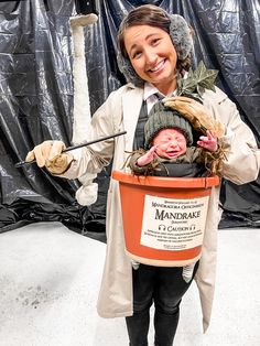 a woman holding a baby in a bucket