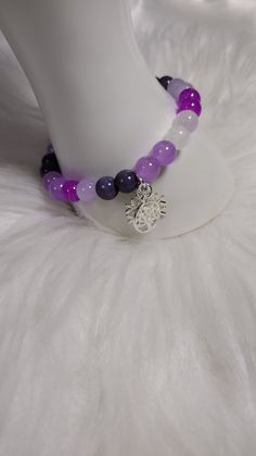 Amethyst Allure Bracelet  with Gemstone Crystal Beads, and Glass Beads, and Silver Charm. Each Charm is Random for Each Bracelet. Adjustable Purple Gemstone Beads Crystal Bracelet, Adjustable Purple Crystal Bracelet With Gemstone Beads, Adjustable Amethyst Beads For Jewelry Making, Purple Crystal Bracelet With Faceted Beads For Healing, Purple Faceted Beads Spiritual Crystal Bracelet, Purple Gemstone Beads For Gift, Spiritual Purple Crystal Bracelet With Faceted Beads, Purple 8mm Beads Bracelet, Purple Beaded Rosary Bracelet