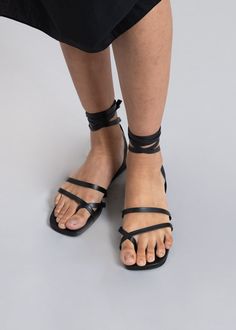 Color: Black Soft leather sandal Wrap around ankle strap Front toe detailing Padded insole Low platform 100% Leather Upper Leather Outsole By Mari Giudicelli. Made in Brazil Black Ankle Strap Wedge Sandals, Black Ankle Strap Sandals With Leather Sole, Black Wedge Sandals With Ankle Strap, Black Sandals With Heel Strap, Open Toe Lace-up Sandals With Strap, Black Sandals With Heel Strap And Flat Heel, Black Flat Heel Sandals With Heel Strap, Leather Lace-up Sandals With Wrapped Heel And Ankle Wrap, Adjustable Platform Lace-up Sandals With Ankle Strap