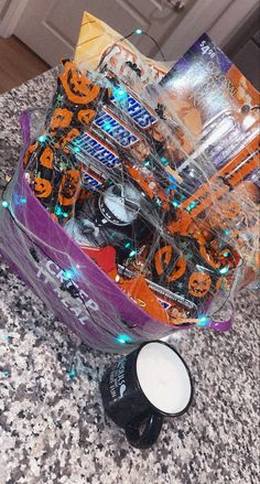 an assortment of halloween candies in a container