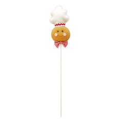 a cake on a stick with a chef's hat on top