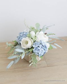 a bouquet of flowers sitting on top of a wooden table