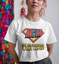 "Looking for the perfect gift for your amazing mom this Mother's Day? Look no further than our Mother's Day t-shirt! This soft and comfortable tee is made from high-quality materials and features a beautiful design that reads \"Mom. Not All Super Heroes Wear Capes .\" It's the perfect way to show your mom how much you appreciate her and all that she does for you. This classic unisex jersey short sleeve tee fits like a well-loved favorite. Soft cotton and quality print make users fall in love with it over and over again. These t-shirts have-ribbed knit collars to bolster shaping. The shoulders have taping for better fit over time. Dual side seams hold the garment's shape for longer.  .: 100% Airlume combed and ringspun cotton (fiber content may vary for different colors) .: Light fabric (4. Mothers Day Tshirt Ideas, Not All Superheroes Wear Capes, All Superheroes, Mom Tshirt, Mothers Day Shirt, Mothers Day T Shirts, Mothers Day Shirts, Super Mom, 7th Birthday