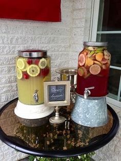 there are three jars with different types of fruit in them on top of a table