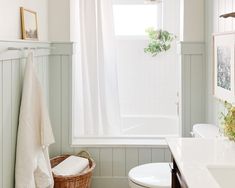 a bathroom with a toilet, sink and bathtub in the corner next to a window