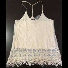 Ivory Double-Layered Camisole. Bottom Layer Is Cotton For Coverage While Top Layer Is Sheer With 3d Design Lace Embroidery. 2 Straps On Shoulders Combine Behind Neck Into 1 Strap For A Racer Back Style. This Versatile Top Can Easily Be Dressed Up Or Down For A Night Out For A Delicate Look Or A Casual Day And Still Look Cute! Brand New With Tag! (Tag Price Torn) Non-Smoking/Pet-Free Home. Lace V-neck Camisole For Summer, Summer Lace Cami Tank Top, Summer Lace Camisole Top, Spring Lace Tank Top, Summer Lace V-neck Tank Top, Fitted Cami Lace Top For Summer, White Lace Tank Top For Party, Elegant Summer Cami Lace Top, Fitted Lace Cami Top For Summer