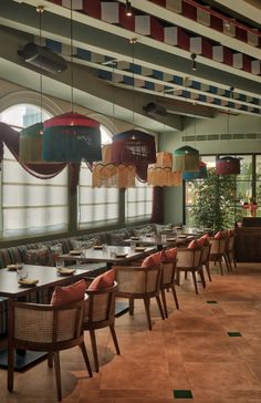 an empty restaurant with tables and chairs in front of large windows that look out onto the outdoors