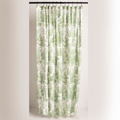 a green and white curtain hanging on a rod