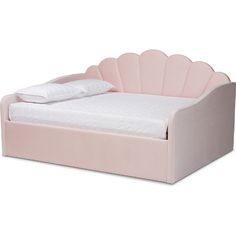 a pink bed with a white pillow on top of it