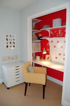 a child's room with red and white walls, a yellow chair in the corner