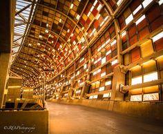 the inside of a large building with lots of windows on it's walls and ceiling