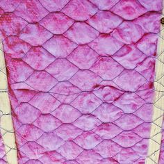 a piece of wood with pink fabric on it