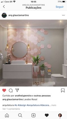 the bathroom is decorated with pink and white hexagonal tiles on the wall, along with gold accents