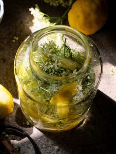 a jar filled with lemons sitting on top of a table