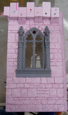 there is a pink brick building with a window