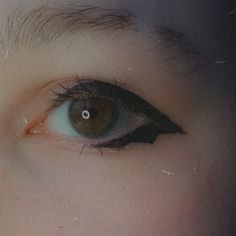 close-up photo of a brown eye with downwards pointing bat wing eyeliner with a grainy vintage filter over the image Bat Winged Eyeliner, Bat Wings Eyeliner, Ghost Concert Outfit Ideas, Bat Wing Makeup, Ghost Eyeliner, Batwing Eyeliner, Bat Stamp, Bat Wing Eyeliner, Bat Eyeliner