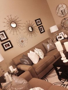 a living room filled with lots of furniture and pictures on the wall above it's coffee table