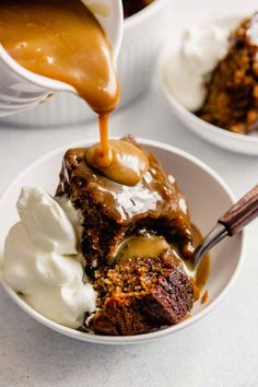 caramel sauce being drizzled on top of cake in a white bowl