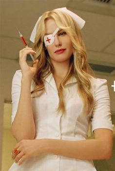 a woman in white nurse outfit holding a syringe