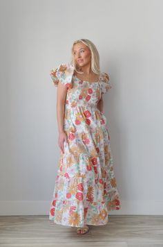 Introducing our smocked puff sleeve flower printed maxi dress! With a square neckline, puff sleeves, and a smocked top, it offers both style and comfort. Includes hidden side seam pockets and a tiered skirt. Perfect for any occasion, this dress is a must-have for your wardrobe. puff sleeves floral print tiered maxi length colorful lined pockets true to size 100% cotton model is wearing a small Square Neck Ruched Maxi Dress For Brunch, Square Neck Maxi Dress With Smocked Back For Brunch, Casual Floral Print Maxi Dress With Puff Sleeves, Square Neck Maxi Dress With Ruffles For Brunch, Floral Print Puff Sleeve Maxi Dress For Brunch, Puff Sleeve Maxi Dress With Floral Print For Brunch, Square Neck Smocked Dress With Floral Print For Brunch, Floral Square Neck Smocked Dress For Garden Party, Square Neck Midi Dress With Gathered Sleeves For Vacation