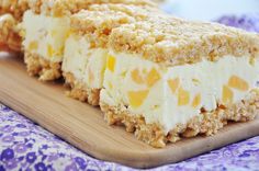 a piece of cake sitting on top of a wooden cutting board next to a purple and white cloth