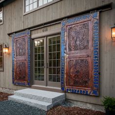 an outside view of a building with two doors and steps