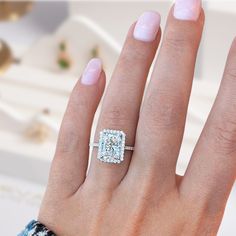 a woman's hand with a diamond ring on it