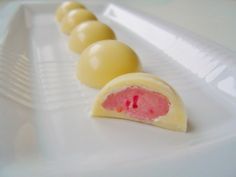 four pieces of chocolate on a white plate