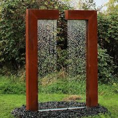 a water fountain in the middle of a garden