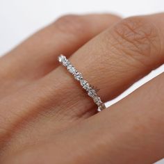 a woman's hand with a diamond ring on it