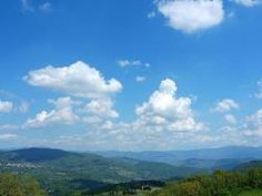 a scenic view of the mountains and valleys from a hill top in the country side