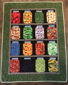 a display case filled with lots of different types of beans and vegtables