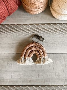 two balls of yarn sitting on top of a wooden table next to scissors and thread