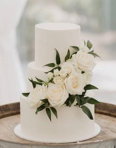 a white wedding cake with flowers on top