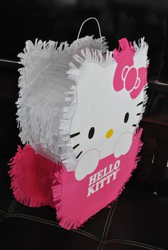 a hello kitty shopping bag is on the floor