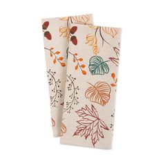 two napkins with leaves on them sitting next to each other in front of a white background