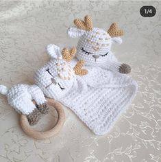 two crocheted giraffes laying next to each other on a bed