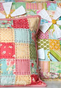 a colorful patchwork pillow with pinwheels on it