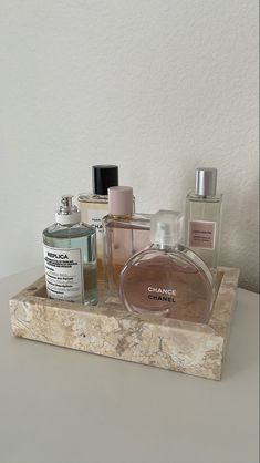 an assortment of perfumes on a marble tray