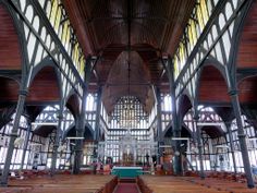 the inside of an old church with wooden pews