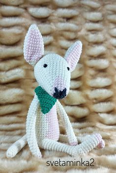 a knitted mouse with a green scarf