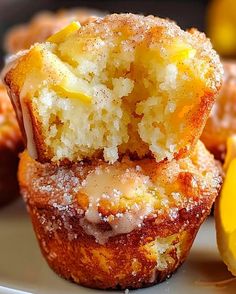 lemon muffins with icing and powdered sugar sitting on a white plate